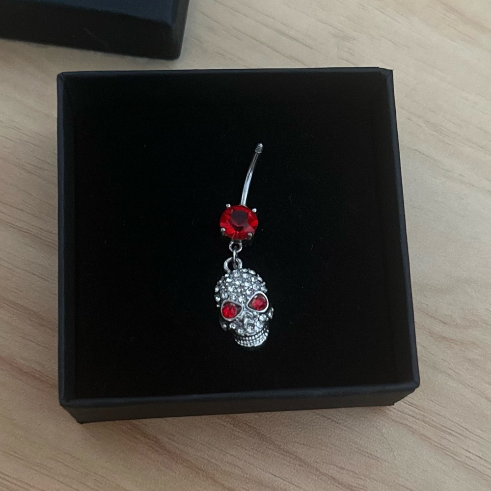 Body Candy Belly Ring; Silver and red rhinestone skull.